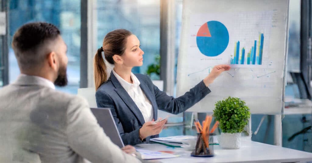 Professional woman showing charts to businessman